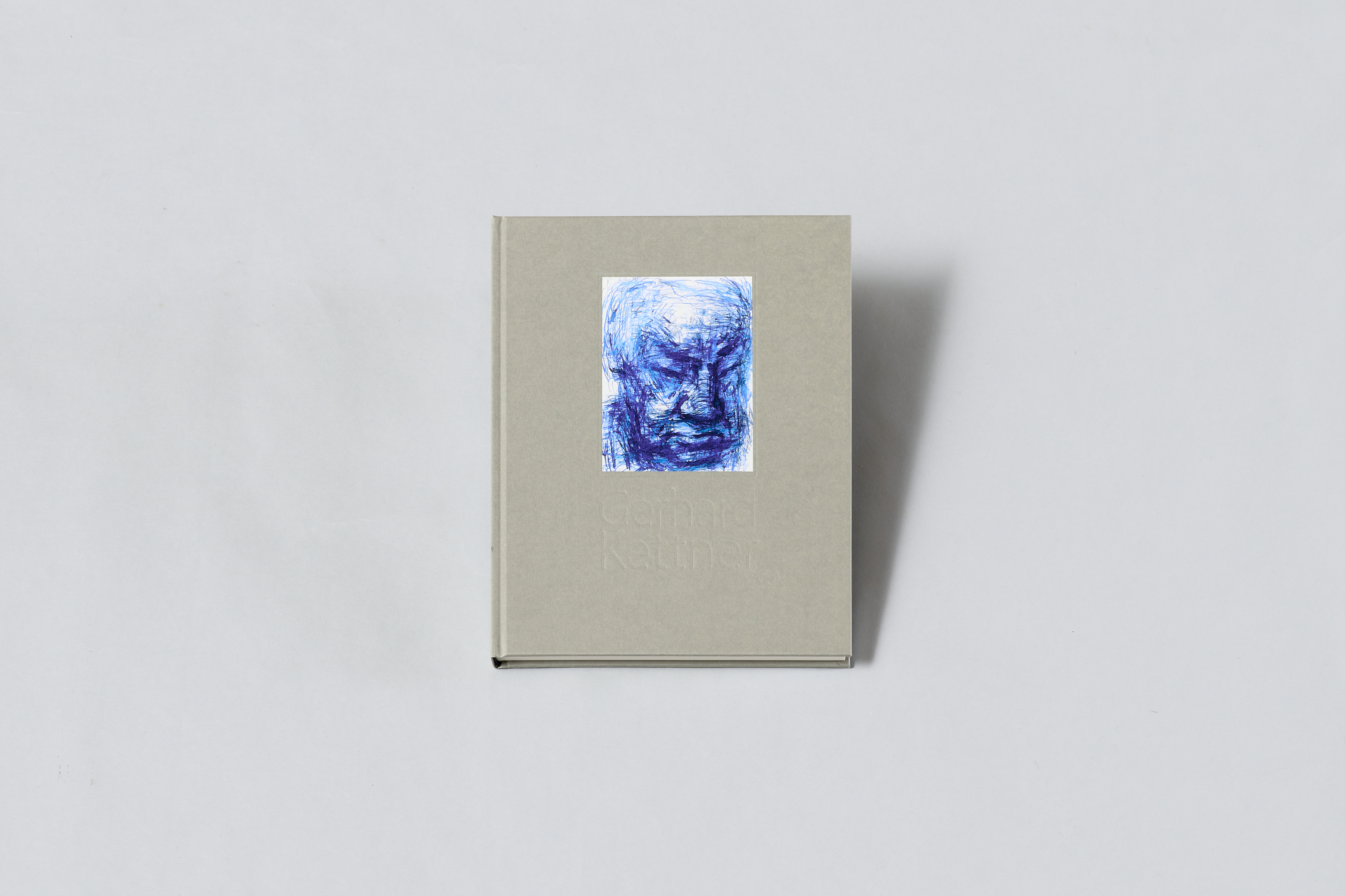 AI generated: It is a book with a grey cover on which an illustration of a face in blue can be seen. The title of the book appears to be partially recognisable.