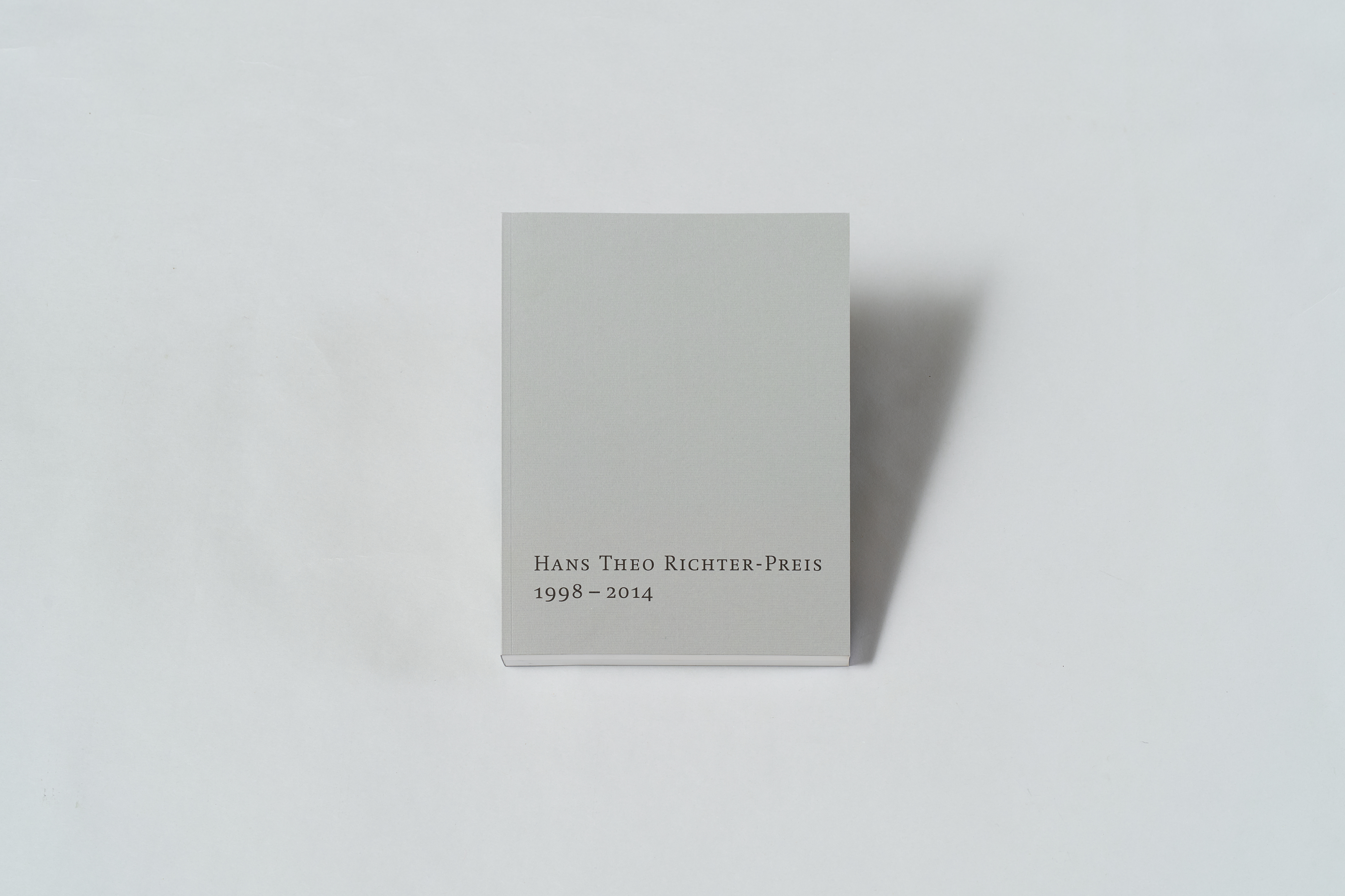 AI generated: The image shows a plain, grey book with the inscription "Hans Theo Richter Prize 1998 - 2014". The background is plain white.
