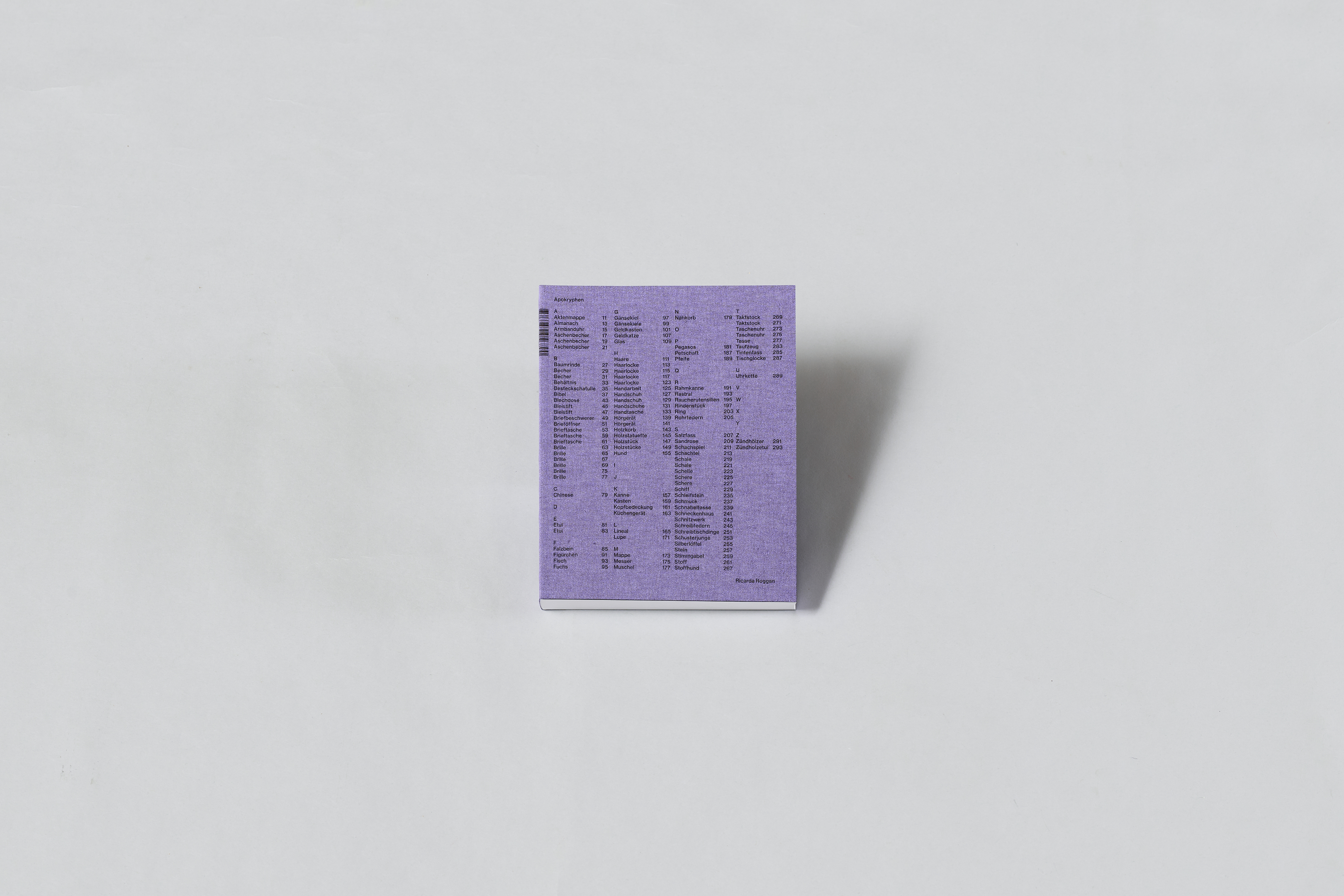 AI generated: The image shows a small, purple-coloured box with a list of printed terms or numbers on it, placed on a light-coloured surface. The main content is the box with its detailed print pattern.