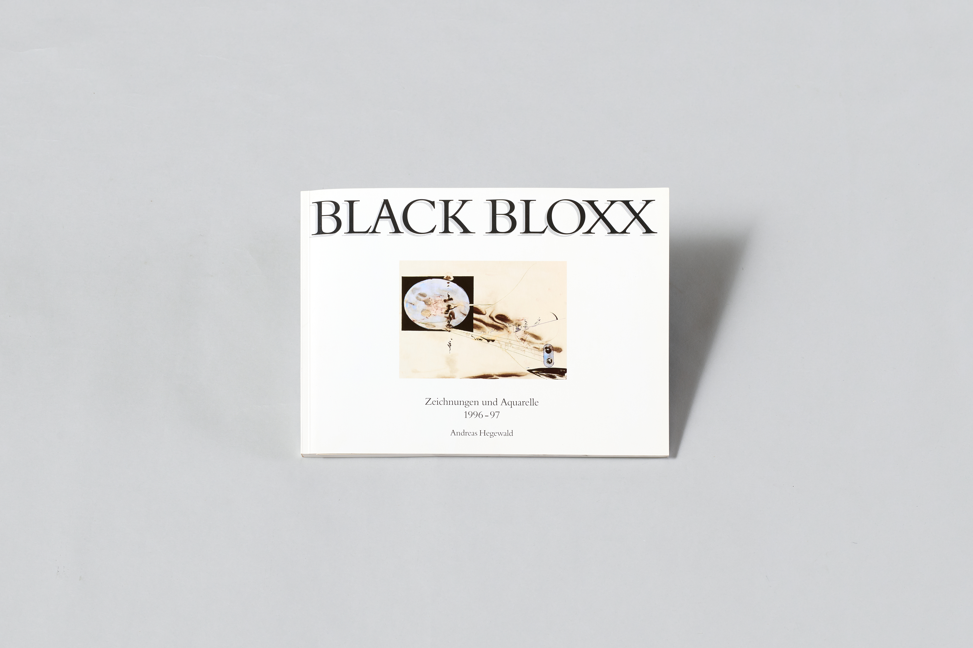 AI generated: The image shows a book entitled "BLACK BLOXX", which presents drawings and watercolours from 1996-97. A work of art is depicted on the cover and the name Andreas Hagenwald is given at the bottom.