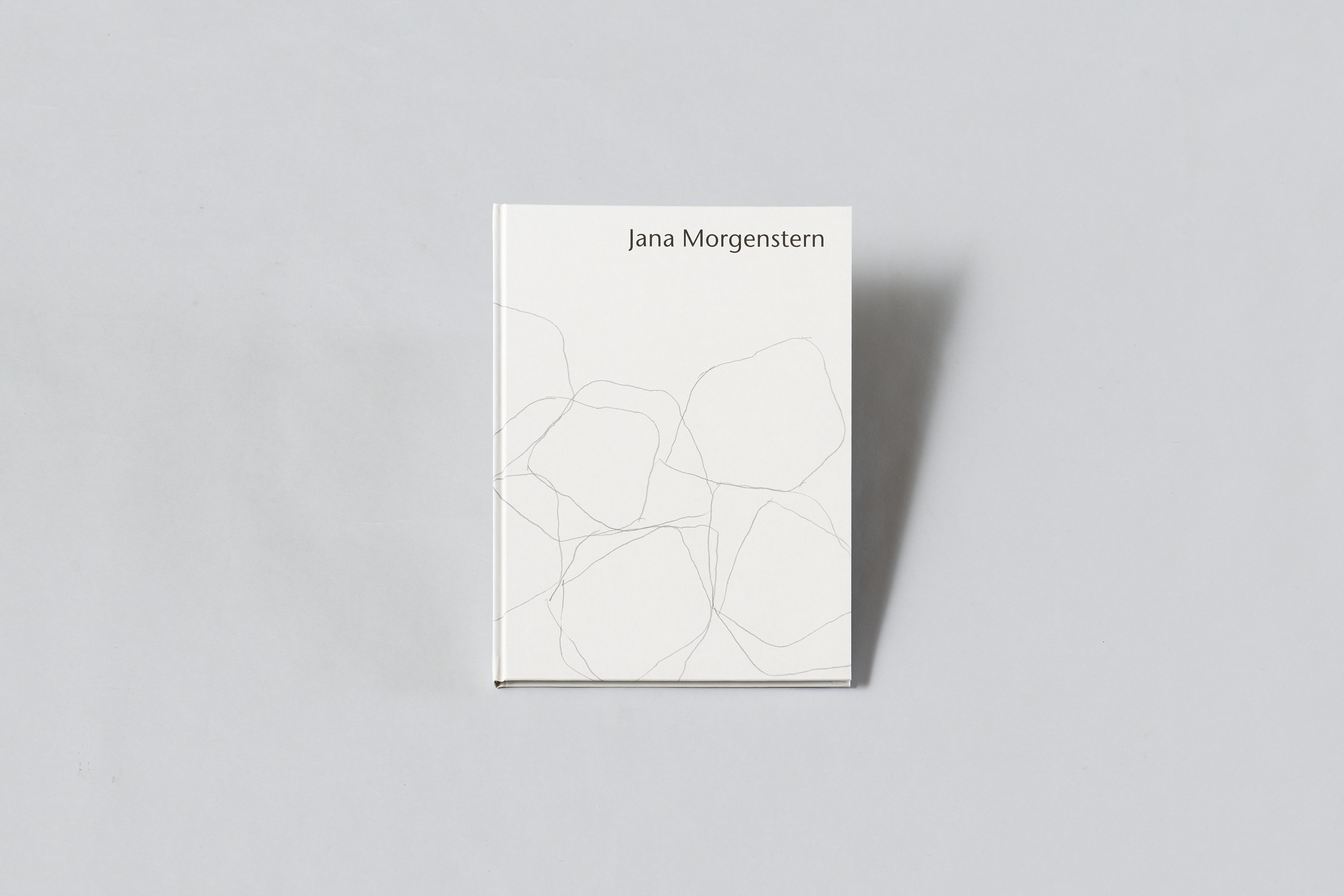 AI generated: The image shows a book with a white cover and the inscription "Jana Morgenstern". The cover is decorated with abstract, sketchy lines.