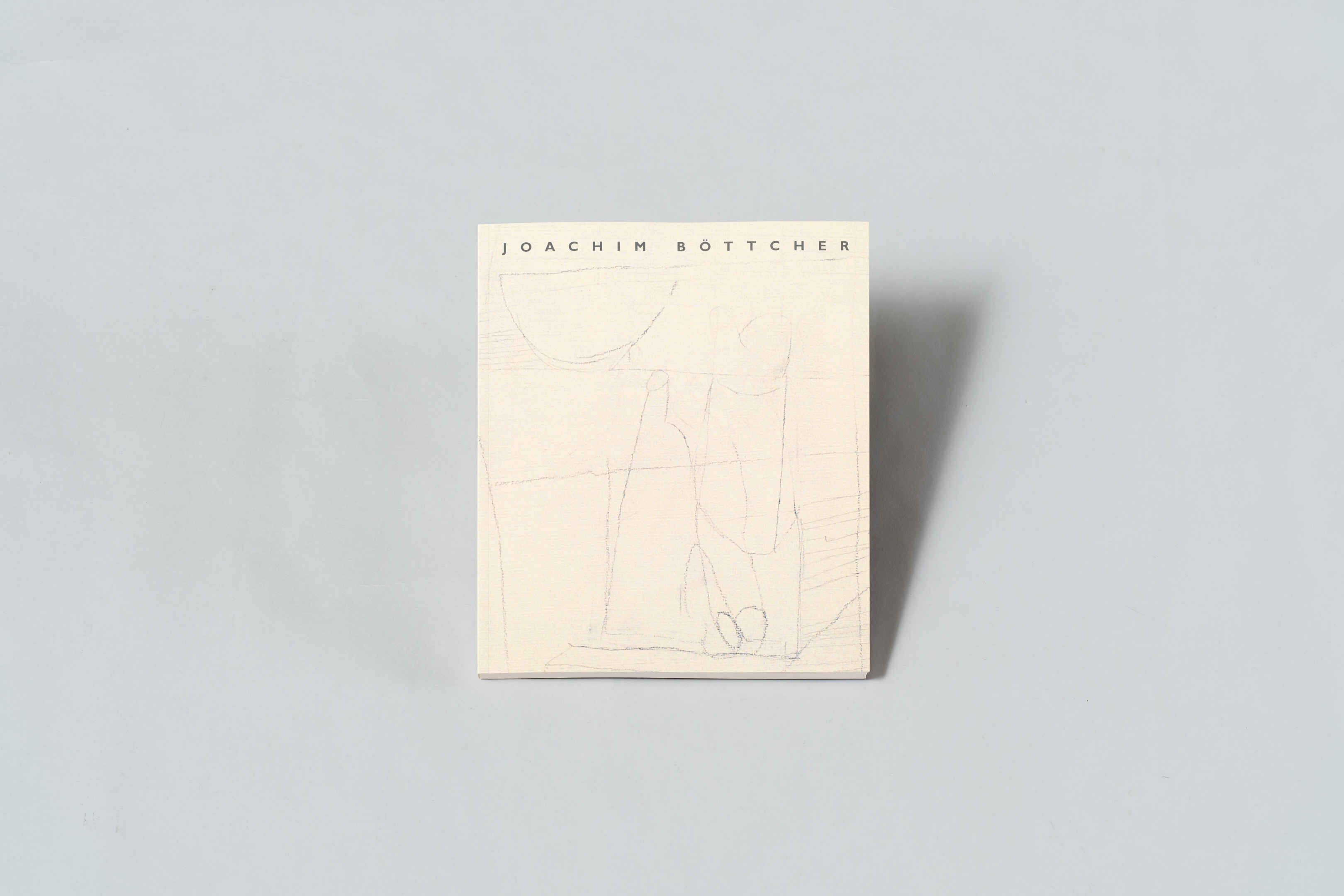 AI generated: The image shows a book with the title "Joachim Böttcher" on a light-coloured background. The cover of the book contains an abstract line drawing.