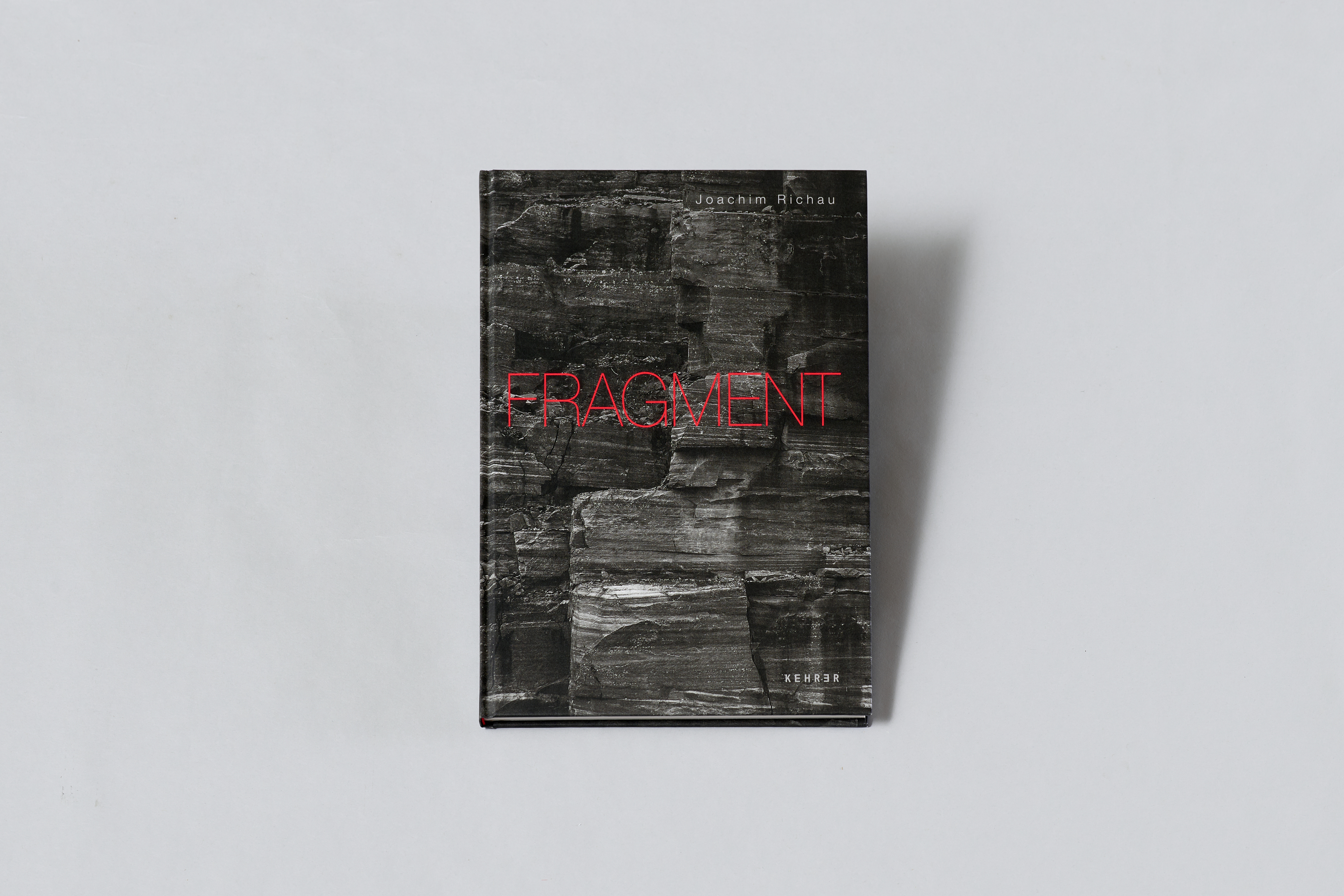 AI generated: The image shows a book with the title "FRAGMENT" lying on a light-coloured background. The book cover is in dark colours and has red lettering.