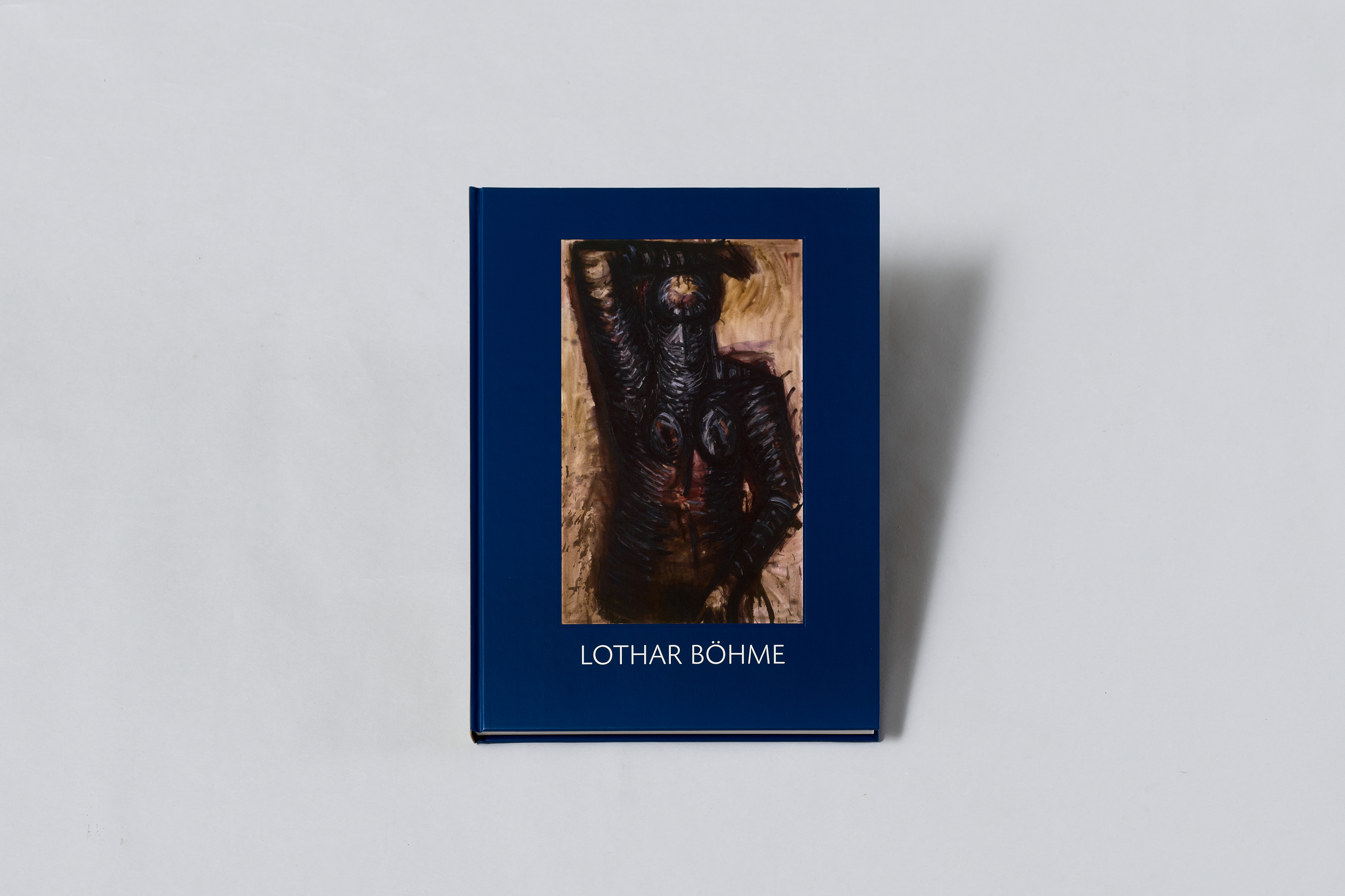 AI generated: The image shows a book with a blue cover and the inscription "Lothar Böhme". The cover shows a work of art depicting an abstract, dark figure.