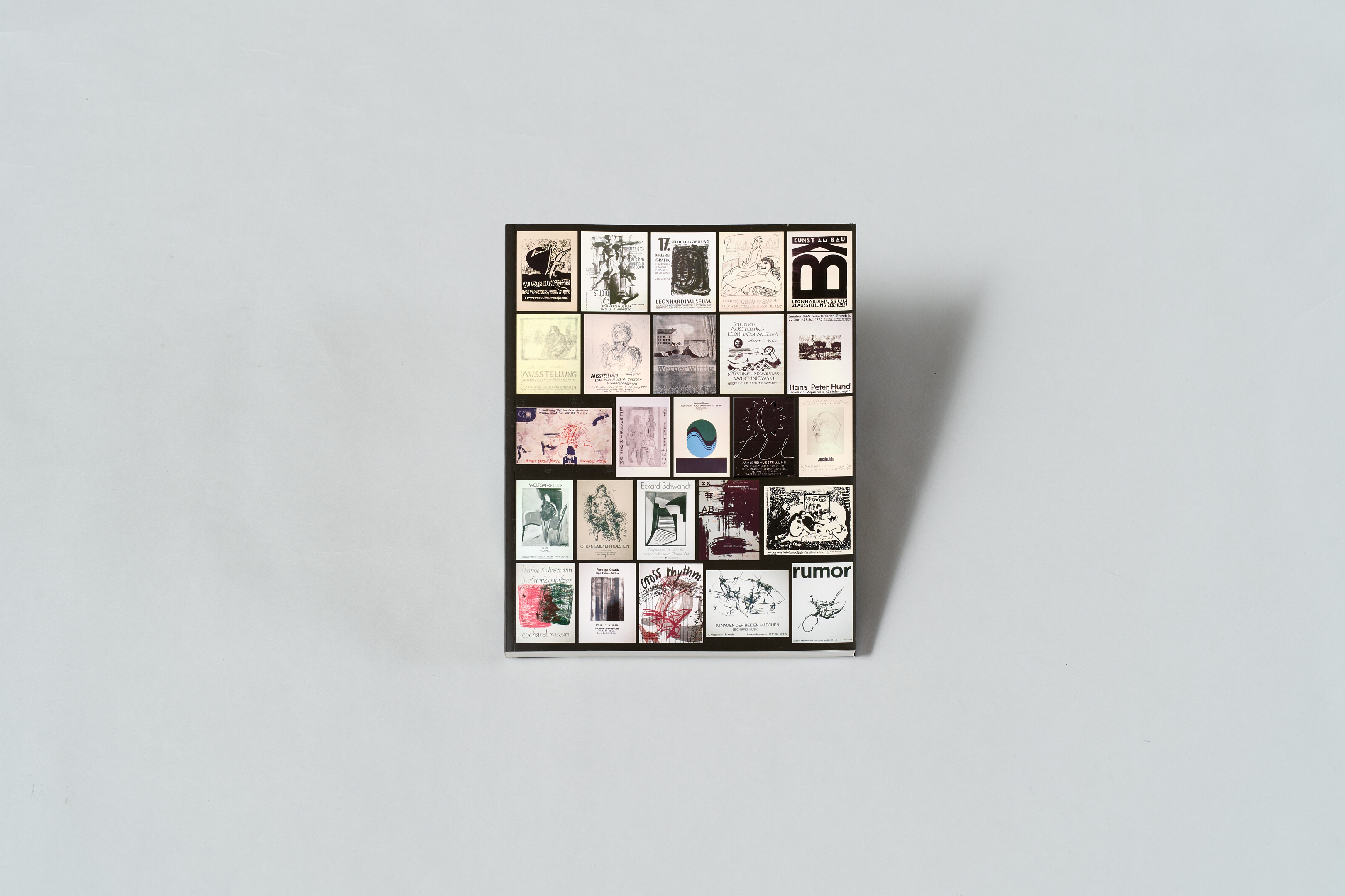 AI generated: The image shows a square area filled with a variety of different black and white and coloured graphics or illustrations in small rectangular fields. The fields appear to come from different styles and contain text and images.