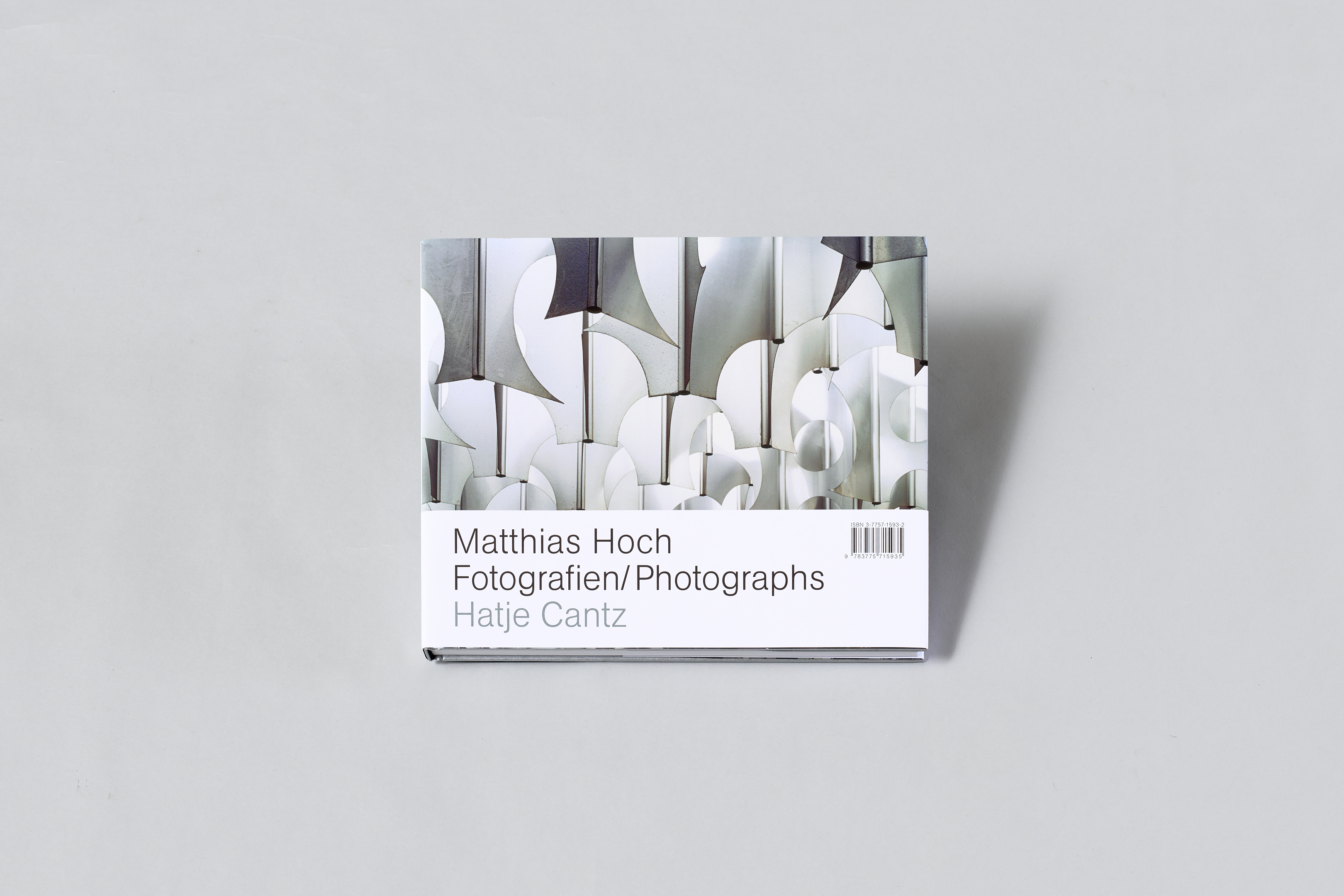 AI generated: The image shows a book entitled "Matthias Hoch Fotografien/Photographs", published by Hatje Cantz. The book cover shows an abstract photo motif.