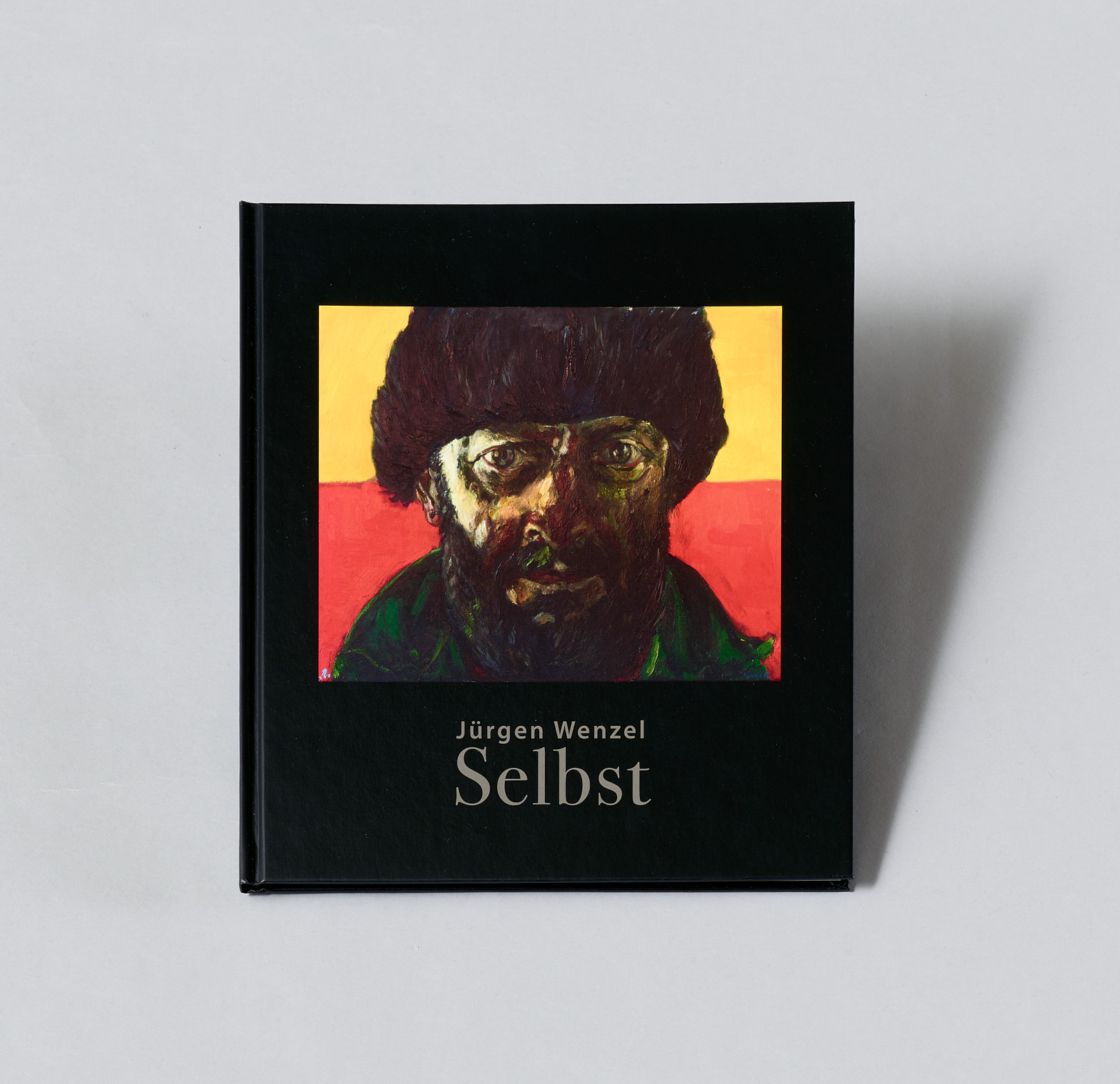 AI generated: The image shows a painted self-portrait of a man with a thick, black hat and beard against a yellow and red background. At the bottom is the name of the artist "Jürgen Wenzel" and the title of the work "Self".